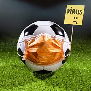 Soccer ball with mask due to air pollution or an epidemic. Protection from viruses, infections, exhaust gases and industrial emissions