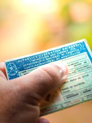 August 28, 2019, Brazil. Man holding document "Carteira Nacional de Habilitação" (CNH). A driver's license attests to a citizen's ability to drive land motor vehicles.