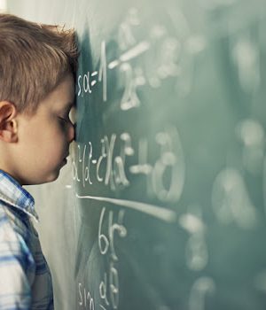 Little boy in math class overwhelmed by the math formula.