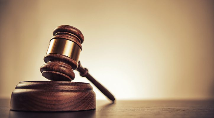 Gavel on desk. Isolated with good copy space. Dramatic lighting.
